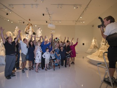 Manouane Beauchamp and Isabelle Binet-Rochette and their guests have a photo taken after a quick engagement ceremony announcement in the heart of the exhibition, Love Is Love: Wedding Bliss for All a la Jean Paul Gaultier at the Montreal Museum of Fine Arts in Montreal on Saturday, August 12, 2017.