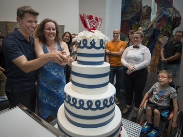 Manouane Beauchamp and Isabelle Binet-Rochette cut a cake after a quick engagement ceremony announcement in the heart of the exhibition, Love Is Love: Wedding Bliss for All a la Jean Paul Gaultier at the Montreal Museum of Fine Arts in Montreal on Saturday, August 12, 2017.