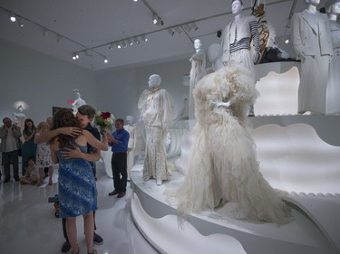 Manouane Beauchamp and Isabelle Binet-Rochette hug and kiss after a quick engagement ceremony announcement in the heart of the exhibition, Love Is Love: Wedding Bliss for All a la Jean Paul Gaultier at the Montreal Museum of Fine Arts in Montreal on Saturday, August 12, 2017.