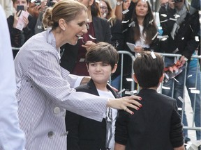 Celine Dion showered with confetti as she leaves the Royal Monceau Hotel with twins Nelson and Eddy.