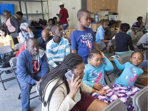 Asylum seekers wait to be processed at the Canada Border Services Agency office in Lacolle, Que., Friday, Aug. 4, 2017.