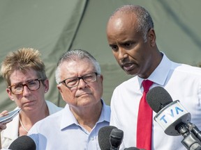 Ahmed Hussen, right, minister of Immigration, Refugees and Citizenship, Ralph Goodale, minister of Public Safety and Emergency Preparedness, and Brenda Shanahan, MP for Chateauguay-Lacolle, comment on the influx of asylum seekers crossing the border into Canada from the United States on Monday, Aug. 21, 2017 near St-Bernard-de-Lacolle.