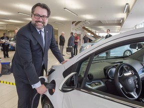 Quebec Environment Minister David Huertel with an electric car as he unveiled his electric car policy in 2016.