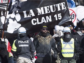 Police hold back far-right protesters during a demonstration in Montreal in March 2017.