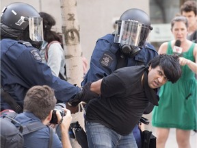 Activist Jaggi Singh is arrested during an anti-racism demonstration in Quebec City Aug. 20, 2017.