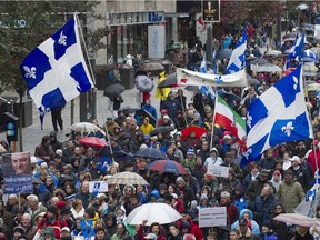 Supporters in favour of Quebec's proposed charter of values take part in a march in Montreal, Saturday, October 26, 2013. Bill 101 arguably made possible the ill-fated, anti-hijab “charter of values” of the former PQ government, and the anti-niqab bill of the present Liberal one, Don Macpherson writes.