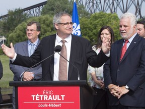 Eric Tetrault, left, candidate for a by-election in the Louis-Hébert riding, speaks at a press conference with Quebec Premier Philippe Couillard Aug. 15, 2017.