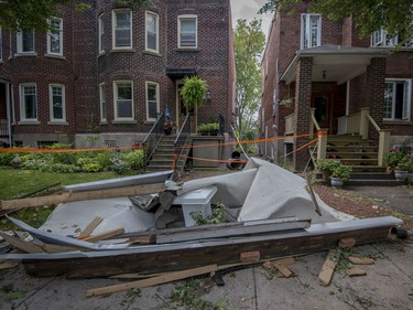 The remains of a roof sit on the side of the road in the Montreal borough of Notre-Dame-de-Grace on Wednesday, August 23, 2017. A severe wind storm that ripped through the area Tuesday August 22 caused tremendous damage to trees, cars and rooftops. THE CANADIAN PRESS/Peter McCabe