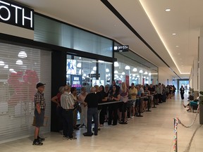 Customers line up to the be the first to shop in Monrtreal's new Saks Off Fifth store Aug. 3, 2017.