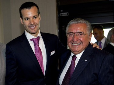 Saputo president and CEO Lino Saputo Jr. and his father Lino, chairman of the board, arrive the the company's annual meeting in Laval, Que., on Tuesday, July 31, 2012.