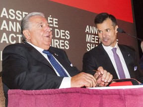 Saputo chief executive Lino Saputo, left, speaks to his son Lino Jr. before the start of the dairy giant's annual meeting on Aug. 1, 2017 in Laval. Saputo is stepping down and will be replaced by his son Lino Saputo Jr.