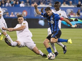 Montreal Impact's Ignacio Piatti, centre, breaks away from Real Salt Lake's David Horst, left, and Stephen Sunday during the second half MLS soccer action in Montreal on Aug. 19, 2017.