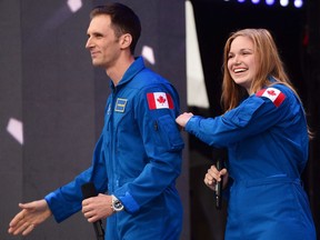 Canada's newest astronauts Joshua Kutryk and Jennifer Sidey acknowledge the crowd during Canada 150 celebrations on Parliament Hill in Ottawa on Saturday, July 1, 2017. Canada's two newest astronauts are already looking beyond the International Space Station as they begin two years of intense basic training.