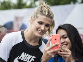 Eugenie Bouchard takes a selfie with a fan after competing in a "60 Second Scramble" promotional event ahead of the Rogers Cup, July 26, 2017.