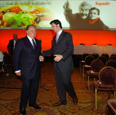 Lino Saputo chairman of the board of Saputo left, and son Lino Saputo Jr. both make their way to the podium to begin the company's annual meeting at the Sheraton Laval hotel in Laval Quebec just north of Montreal Tuesday July 31 2007.