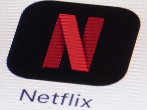 The Netflix logo is shown on an iPhone.