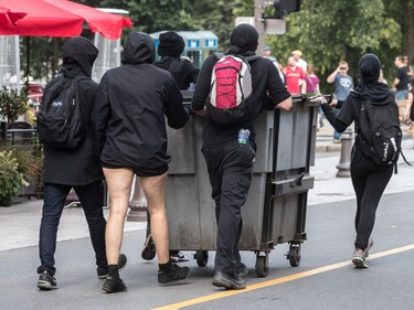 The far-right group La Meute and counter-protesters, organized by a group called Citizen Action Against Discrimination as well as the Ligue anti-fasciste Québec clashed in Quebec City, on Sunday, August 20, 2017. A group of masked demonstrators pushed a garbage can to where the police were positioned.