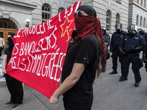 Masked counter-protesters demonstrating against the far-right group La Meute in Quebec City, on Sunday, Aug. 20, 2017.