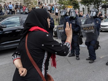 The far-right group La Meute and counter-protesters, organized by a group called Citizen Action Against Discrimination as well as the Ligue anti-fasciste Québec clashed in Quebec City, on Sunday, August 20, 2017. A woman attempted to buy some time with the police to calm down her fellow protesters.
