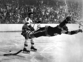 Bobby Orr is tripped by St. Louis defenceman Noel Picard after beating goalie Glenn Hall in OT to win the 1970 Stanley Cup.