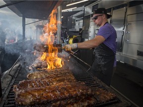 Sandy Hartley of Ribs Royale tends to the barbecue during the Montreal RibFest held last month in Pierrefonds.