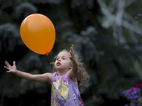 Four-year-old Ciella McCrory chase a balloon at a pary at the Dollard-des-Ormeaux Public Library Aug. 26, 2017.