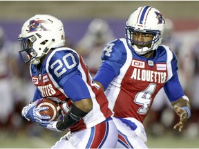 Montreal Alouettes quarterback Darian Durant, right hands the ball to running back Tyrell Sutton  during first half of Canadian Football League game against the Ottawa Redblacks in Montreal Thursday August 31, 2017.
