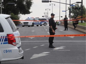 Montreal police officers at scene of police shooting at the corner of Pie-IX and Charleroi Sts. in Montreal North on Monday.