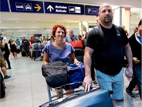 Claudia Duclos and Derek Pearson arrive at Trudeau airport on Wednesday after being evacuated from the Dominican Republic ahead of Hurricane Irma.