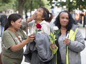 Jessie, Annisee Papialuk and Bunny Paris mourn as attend a vigil to remember two Inuit women who died — Siasi Tullaugak and Sharon Barron — in Montreal, Sept. 8, 2017.