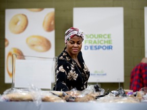 Juliette Nwigudu checks the bread selection at the Welcome Hall Mission in Montreal on Tuesday, Sept. 12, 2017.