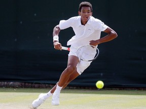 Montreal's Félix Auger-Aliassime returns to Alex De Minaur of Australia during their boys' singles match of the Wimbledon Tennis Championships in London, in a July 7, 2016, file photo.