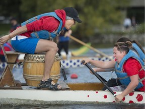 Drummer Gabriel Gan left, and paddler Audrey-Maude Lavoie, of team Feel the Heat, turn up the volume during the annual Dragon Boat Race & Festival in Lachine, Sept. 9.