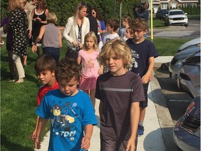 Students from École primaire St-Rémi in Beaconsfield use the new sidewalk which makes walking a biking to school a whole lot safer.