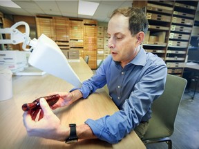 Christian Gates St-Pierre examines a bottle found at a dig in Outremont during a hunt for Hochelaga, the Iroquoian village Jacques Cartier visited in 1535.