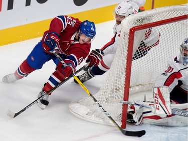 Montreal Canadiens left wing Daniel Carr attempts a wraparound against Washington Capitals goalie Philipp Grubauer as Capitals Madison Bowey tries to tie up Carr during pre-season NHL play at the Bell Centre in Montreal on Wednesday September 20, 2017.