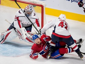 Montreal Canadiens centre Byron Froese grimaces as he is kneed by Washington Capitals Wayne Simpson during preseason NHL play at the Bell Centre in Montreal on Wednesday September 20, 2017. Washington Capitals goalie Philipp Grubauer looks on.