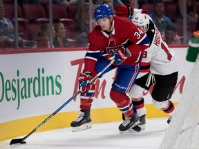 Montreal Canadiens right wing Michael McCarron carries the puck behind the net as New Jersey Devils center Nico Hischier follows behind during pre-season NHL action at the Bell Centre in Montreal on Thursday September 21, 2017.