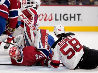 Montreal Canadiens goalie Carey Price falls over backwards after New Jersey Devils centre Kevin Rooney crashed in to him during pre-season NHL action at the Bell Centre in Montreal on Thursday September 21, 2017.