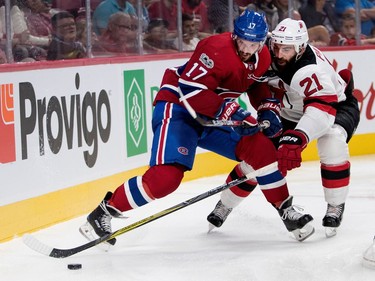 Montreal Canadiens centre Torrey Mitchell gets caught up with New Jersey Devils right wing Kyle Palmieri during pre-season NHL action at the Bell Centre in Montreal on Thursday September 21, 2017.