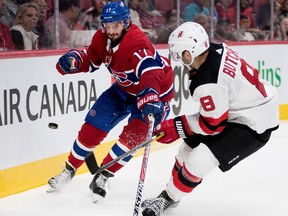 Montreal Canadiens centre Torrey Mitchell grimaces as he tries to keep New Jersey Devils defenceman Will Butcher from the puck during pre-season NHL action at the Bell Centre in Montreal on Thursday September 21, 2017.