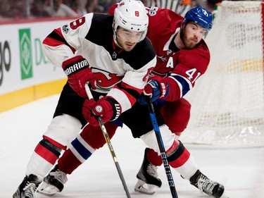 Montreal Canadiens centre Paul Byron struggles to get around New Jersey Devils defenceman Will Butcher during pre-season NHL action at the Bell Centre in Montreal on Thursday September 21, 2017.