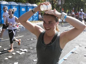 Camille Perreault tries to cool down while taking part in the half-marathon on Sunday, Sept. 24, 2017. The full 42.2-kilometre event was cancelled becauase of concerns about the heat wave.