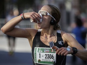 Runner Kayla Segal drinks water as she takes part in the Rock 'N' Roll Montreal Marathon in 2016.