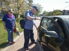 ABOVAS volunteer Malcolm Johnson opens his car door for Andrée Saint-Denis outside her Pointe-Claire home, before he takes her into Montreal for a doctors appointment last Friday.