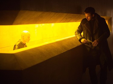 Ryan Gosling (right) as K, in a scene from Denis Villeneuve's Blade Runner 2049. Villeneuve says his noir inspiration for this film came from his memories of Quebec's bleak, cold winters. (Stephen Vaughan / Warner Bros. via AP)