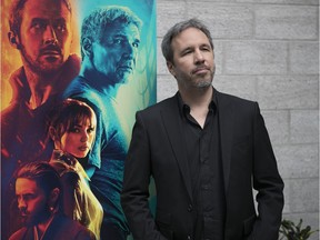 Quebec director Denis Villeneuve with a poster for Blade Runner 2049 in 2017.