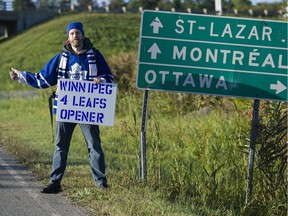 Toronto Maple Leafs fan Clancy McNamara, who started his trek in Dollard-des-Ormeaux early last Friday, hitchhikes along Highway 40 near Hudson. McNamara is podcasting his trip to Winnipeg, with the hope of arriving in the city for the Leafs season NHL opener verse the Jets.