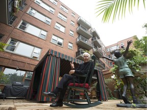 Marvin Birnbom poses on one of the terraces in his apartment filled with flowers, shrubs and whimsical ornaments in Côte-de-Neige in Montreal.