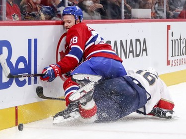 Canadiens' Jakub Jerabek keeps his eye on the puck as he falls over Florida Panthers' Aleksander Barkov in Montreal on Friday, Sept. 29, 2017.